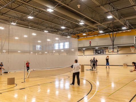 People playing badminton in a community center