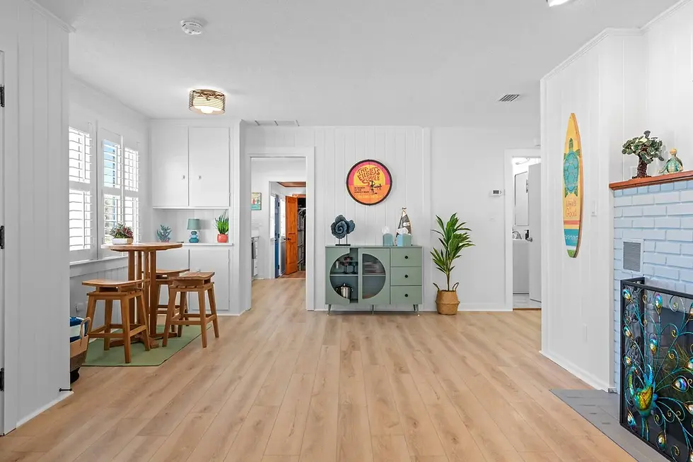 Bright coastal living room with white cabinetry and wood accents at Vilano Vista, designed to attract guests when planning