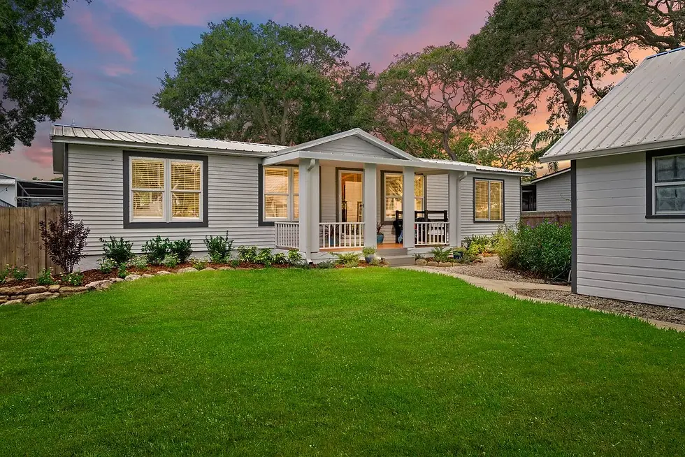 Modern farmhouse villa with white siding and metal roof at dusk, showing revenue management appeal for luxury St. Augustine