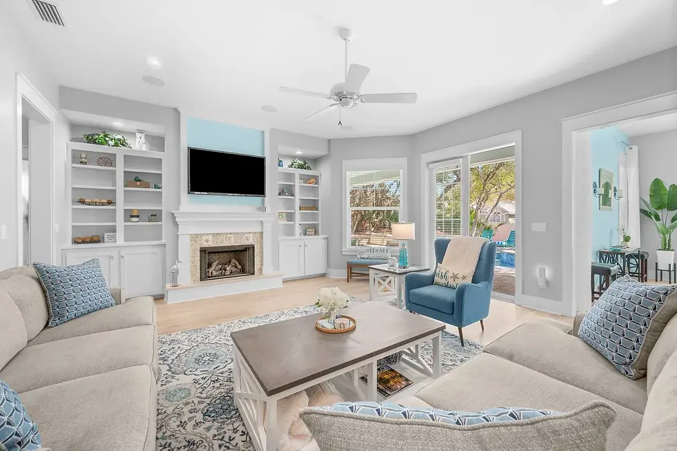 Bright coastal living room with ocean views and built-in fireplace in St. Augustine vacation rental