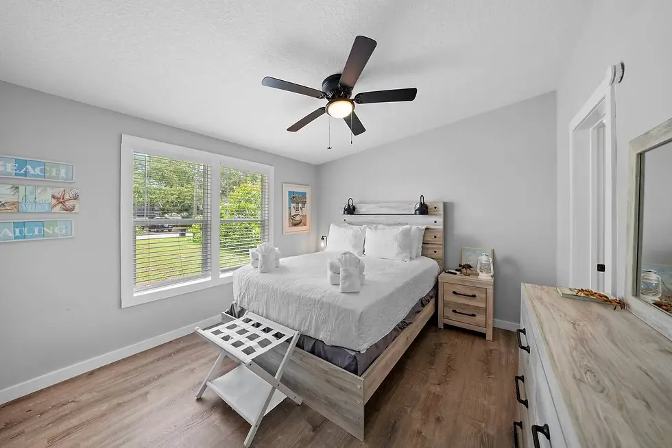 Coastal master bedroom with king bed and natural light at St. Augustine Beach property