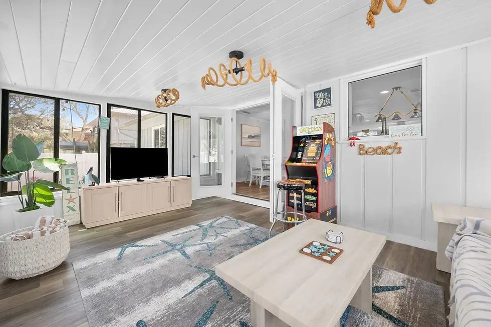 Bright coastal living room with shiplap, ocean views, and nautical décor in St. Augustine FL vacation rental