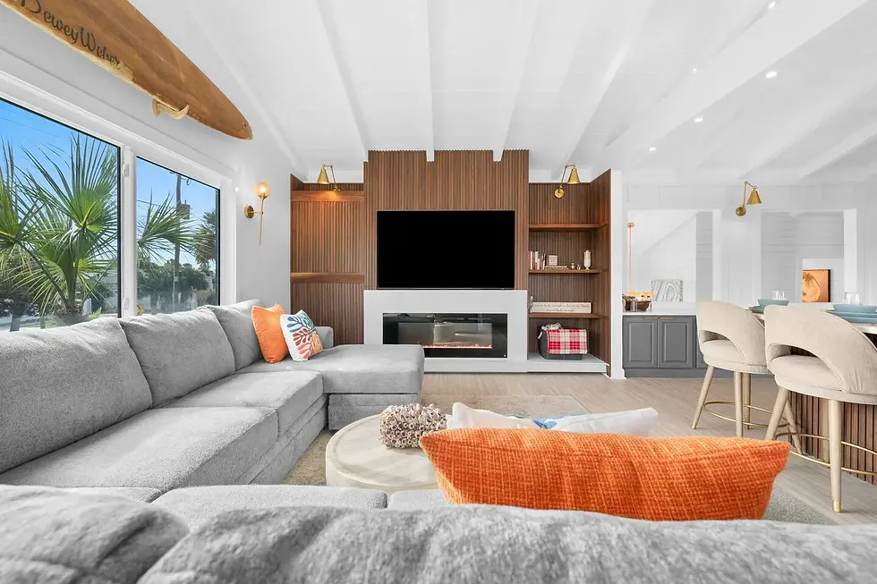 Modern coastal living room with gray sectional sofa and fireplace in St. Augustine beach house