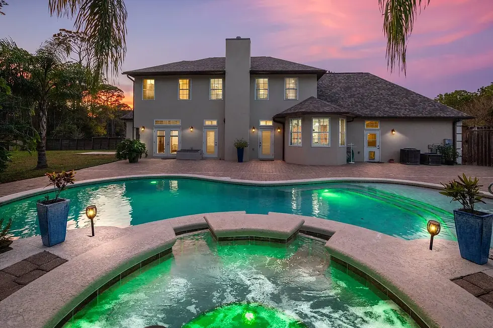 Luxury Airbnb pool with spa and resort-style backyard at twilight, demonstrating revenue optimization priorities for