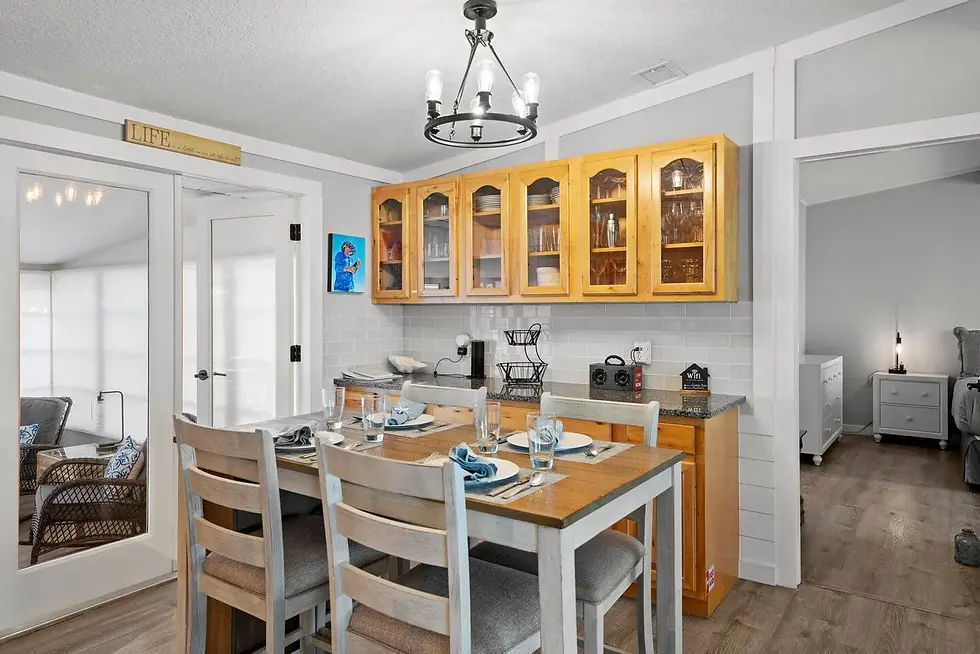 Modern kitchen with wood cabinetry and coastal décor at St. Augustine vacation rental, perfect for seasonal demand