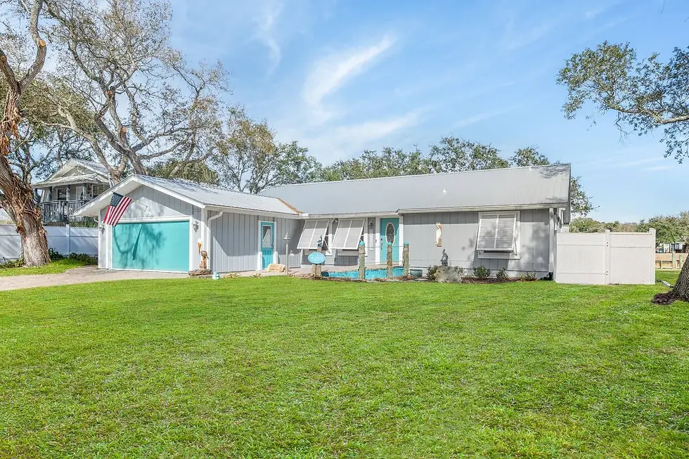 Turquoise and white coastal vacation rental exterior with nautical decor in St. Augustine FL