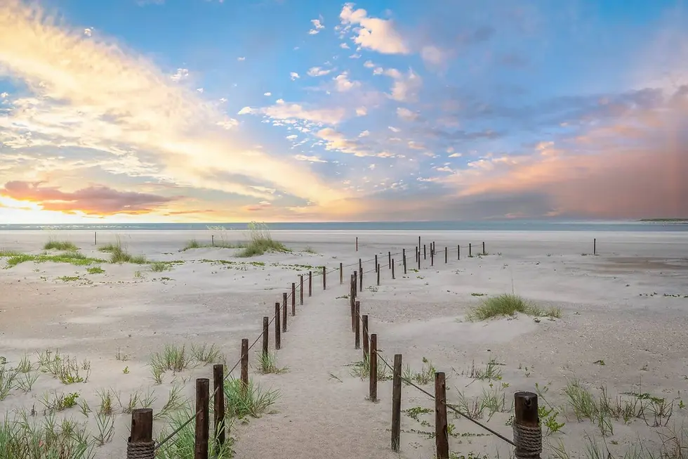 Beach sunset with sandy shoreline, dune markers, and ocean view in St Augustine FL coastal rental