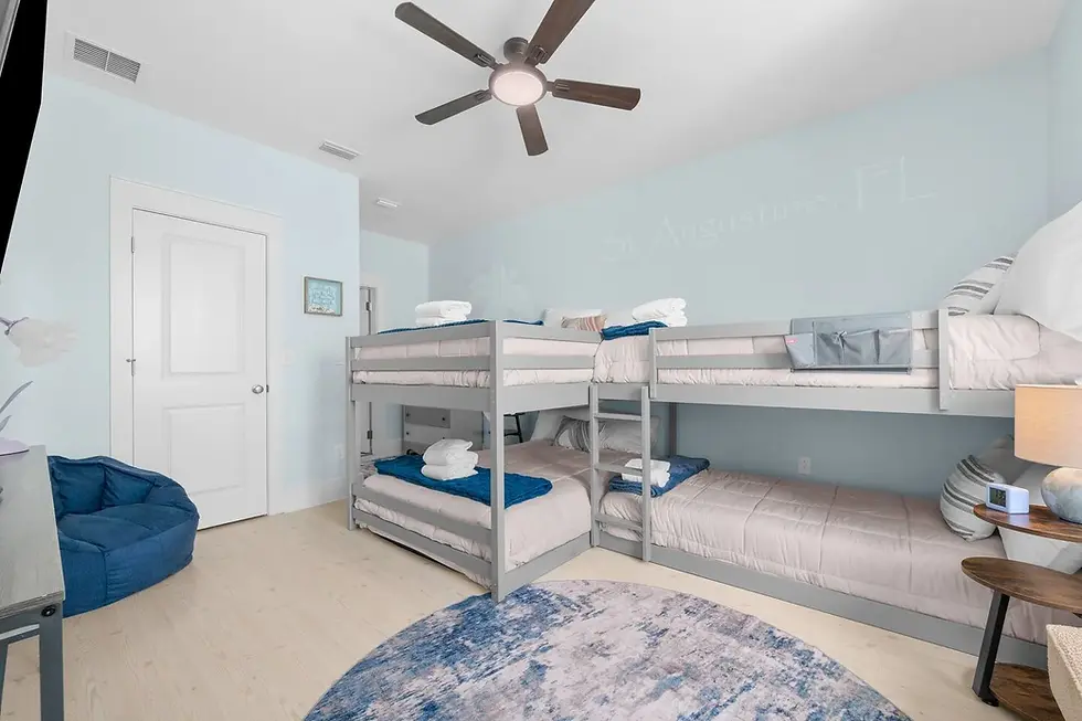 Bright bunk room with coastal decor and group bedding in St. Augustine vacation rental