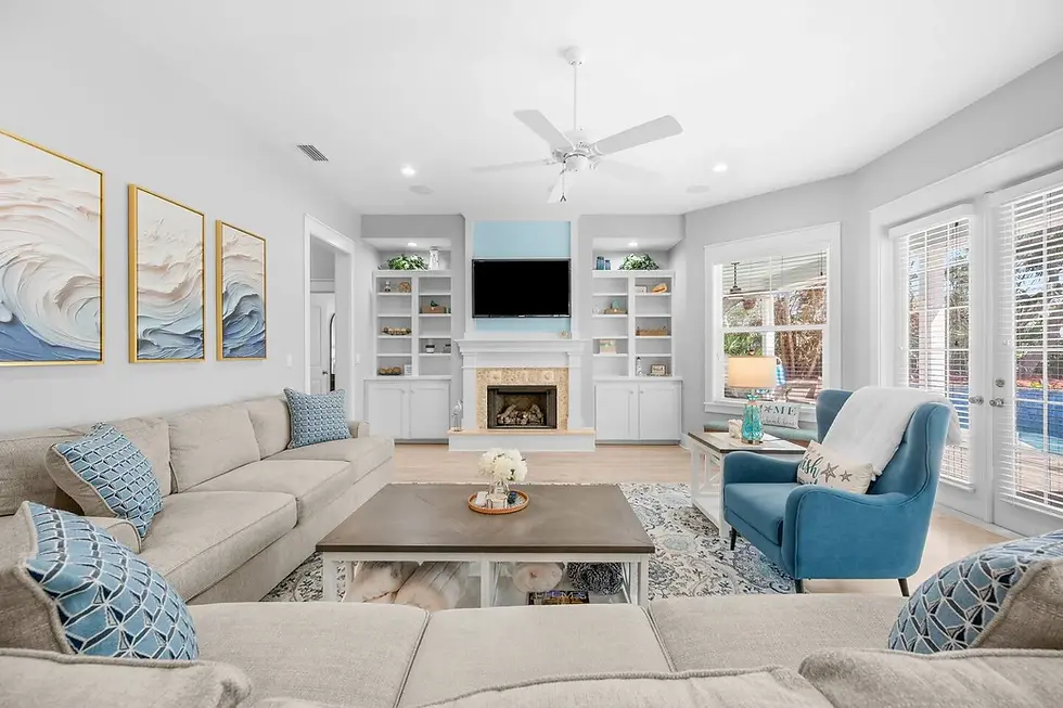 Coastal living room with fireplace and built-in shelving, showcasing 5-star guest experience design in St. Augustine FL
