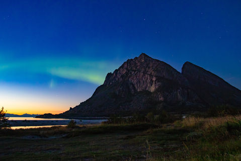 northern lights behind mountain