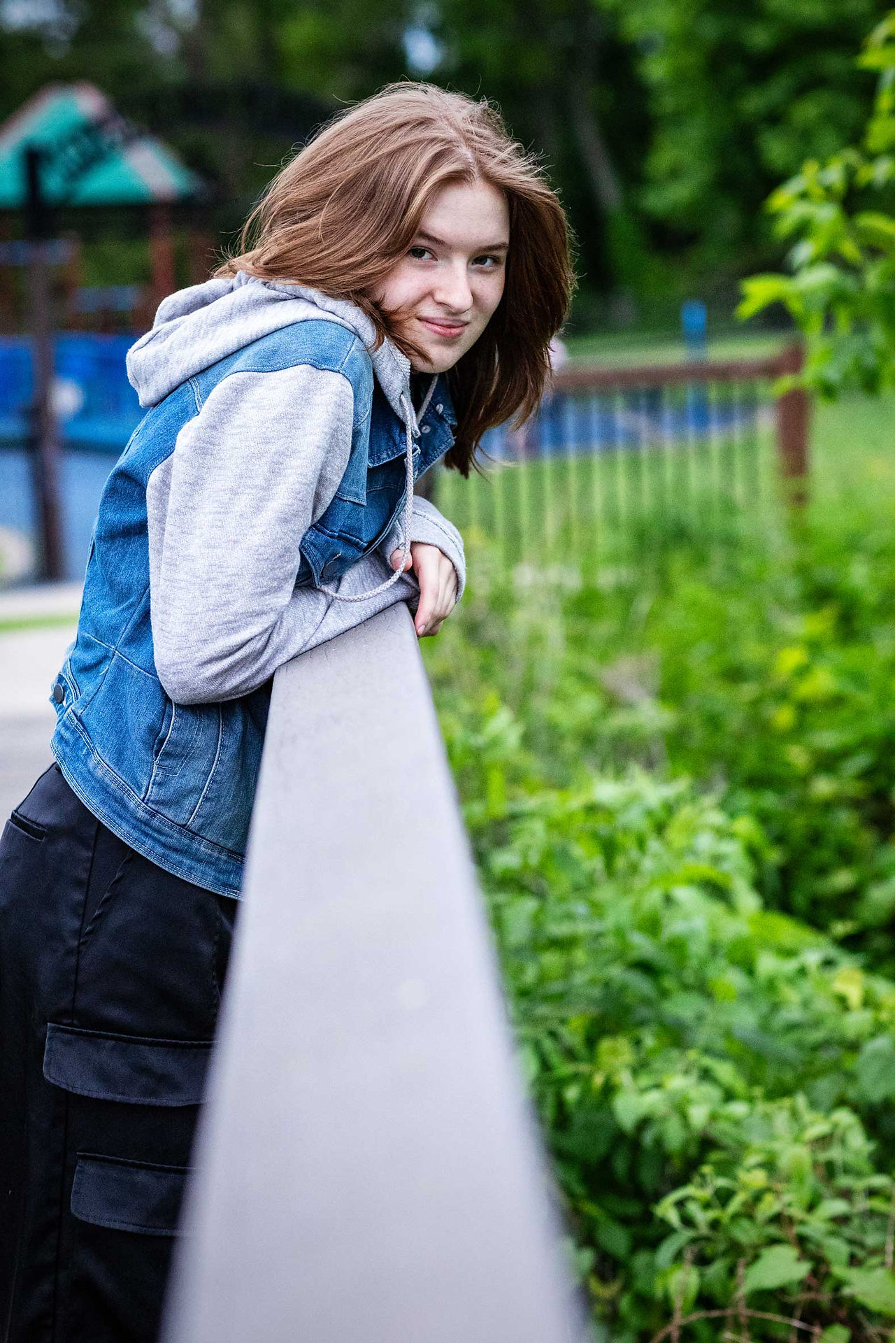 Senior girl leaning on a bridge