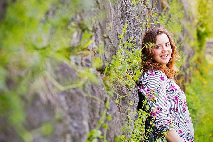 High School girl leaning against stone wall, Jordan, NY
