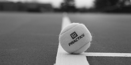 green Wilson practice tennis ball in fie
