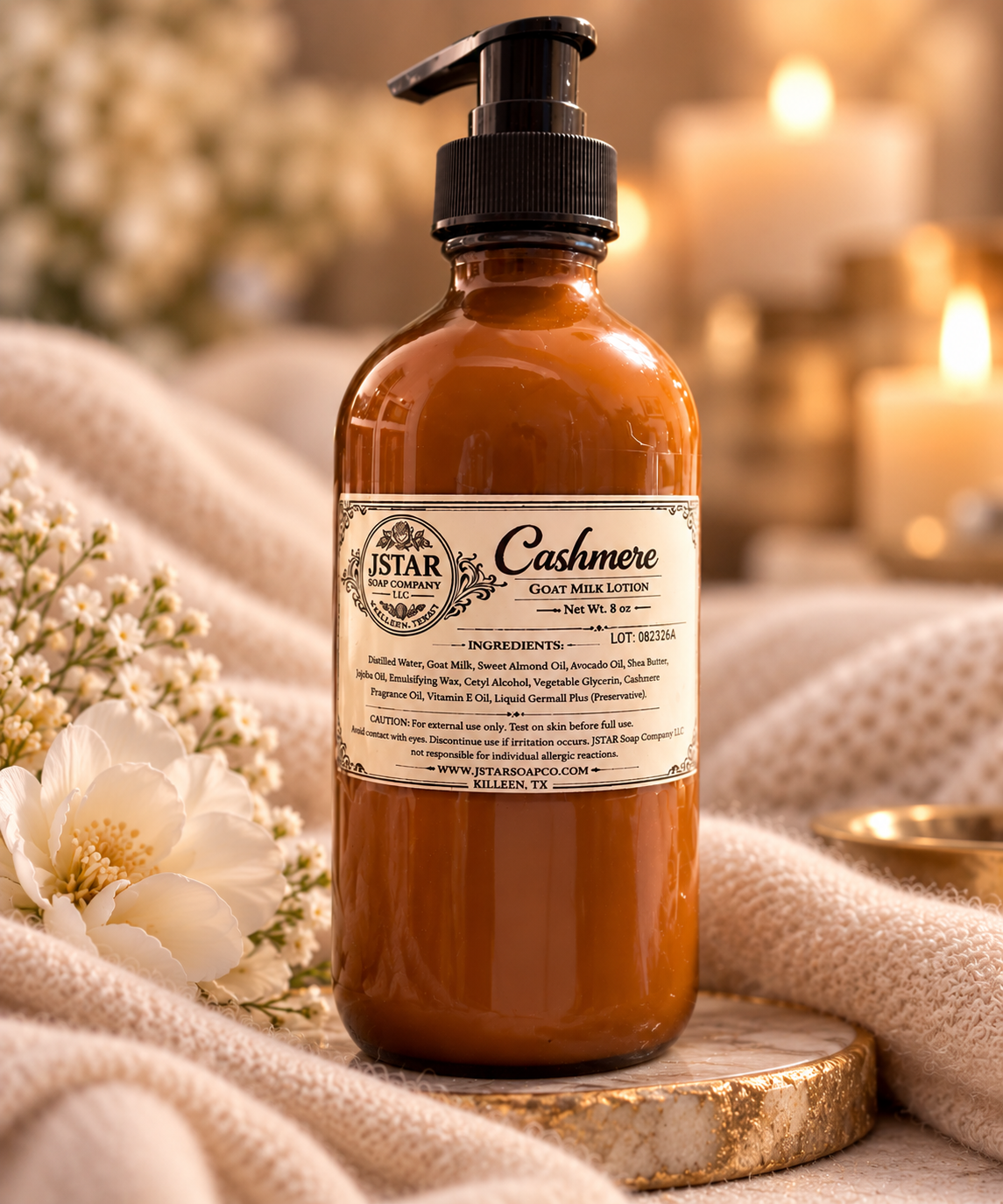 JSTAR Cashmere Goat Milk Lotion in an 8 oz amber glass pump bottle with a warm, luxurious cashmere spa setting.