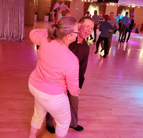 Couple dancing East Coast Swing at a Bravo Dance Studio party.