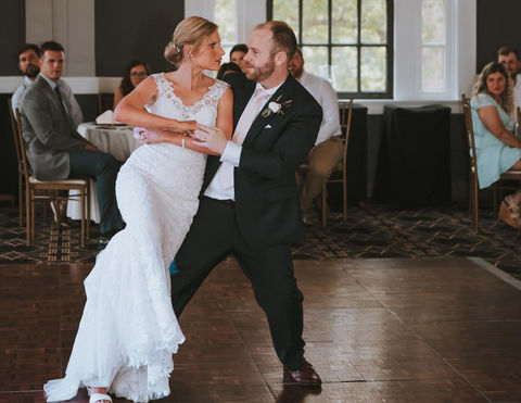 Wedding couple performing a deep dance at their reception after lessons at Bravo Dance Studio.