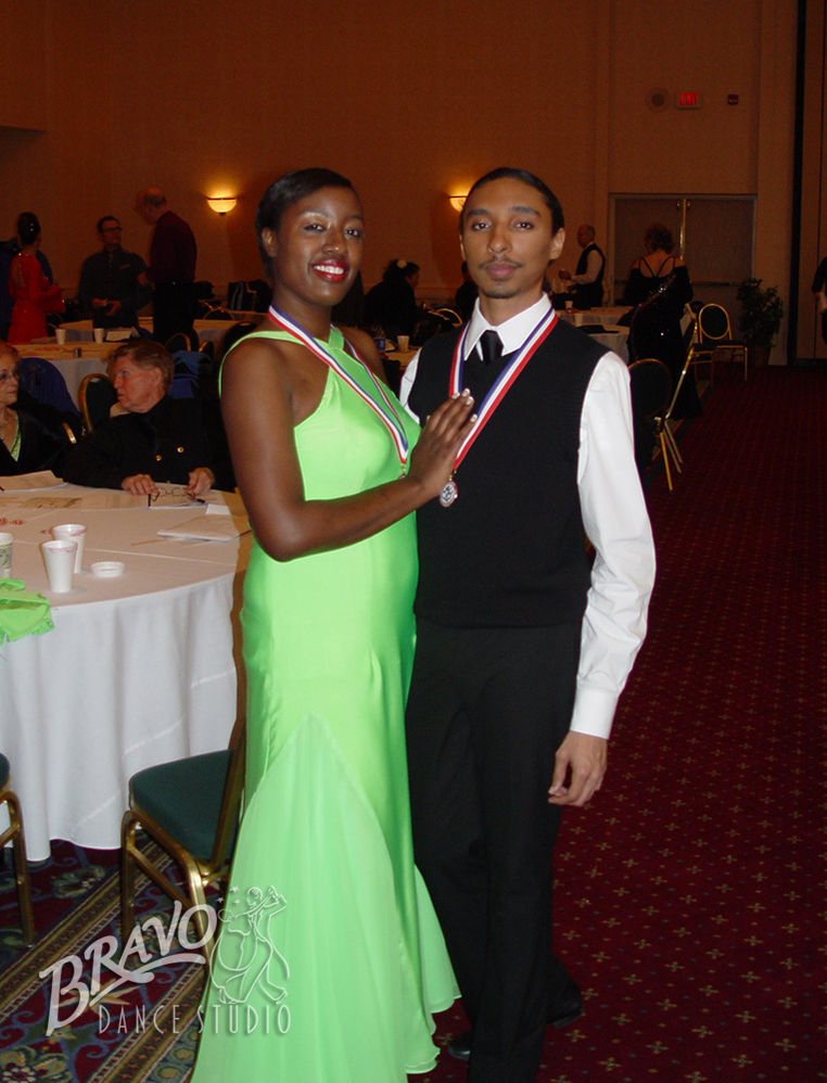 African American couple with medals after a successful dance competition.