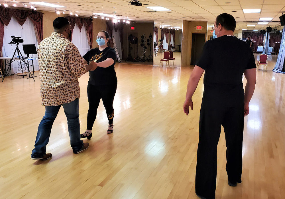 Alex teaching husband and wife new steps during private lesson