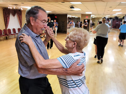 Beginner couple smiling and enjoying their first dance class.