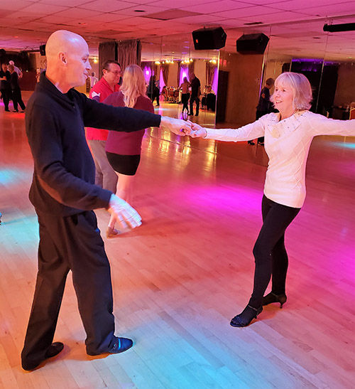 Couple enjoying a dance and social event at Bravo Dance Studio.