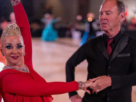 Ann and her student competing at a ballroom dance competition.