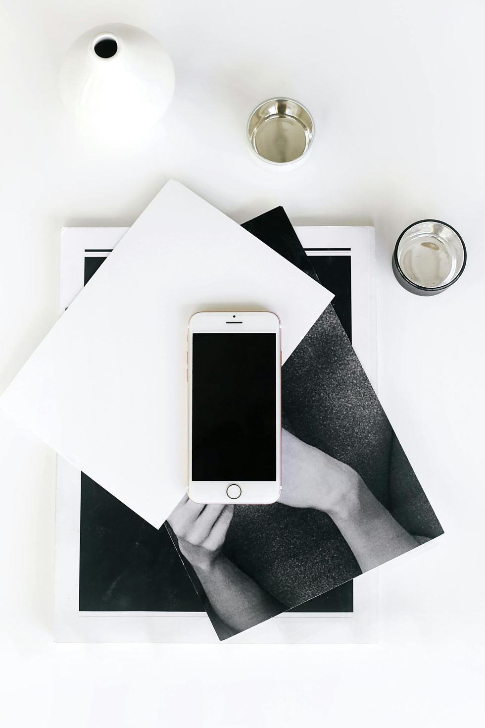 Flat Lay of mobile smart phone, papers, laptop