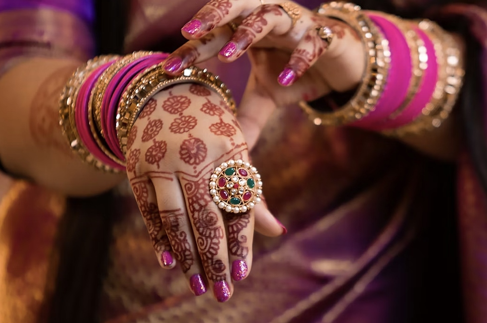 Back of hand mehndi with circular butti motifs and swirl designs