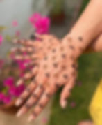 Back hand mehndi design featuring small leaf-like clusters