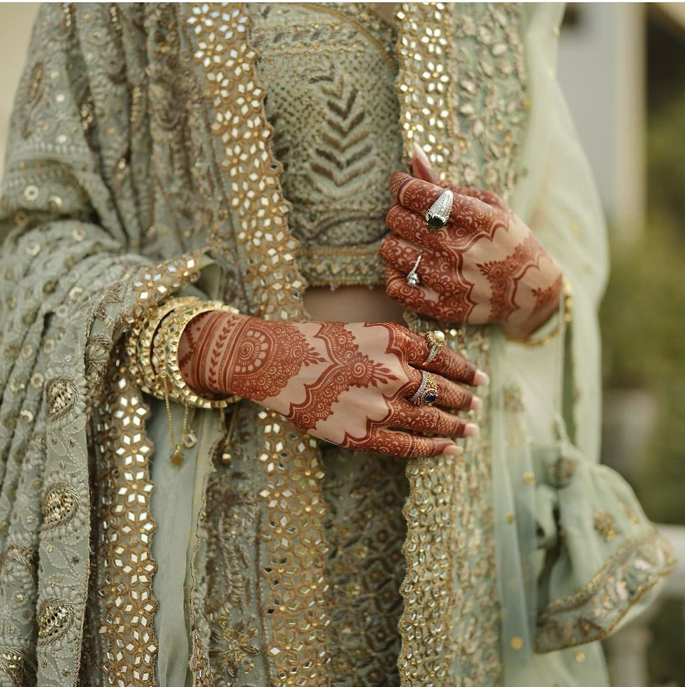 Bridal back hand mehndi with scalloped border and ornamental detailing