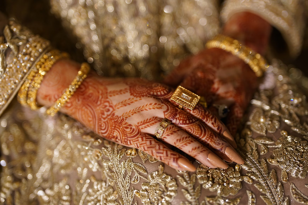 hands adorned with red back hand mehndi featuring leaf trails and detailed patterns