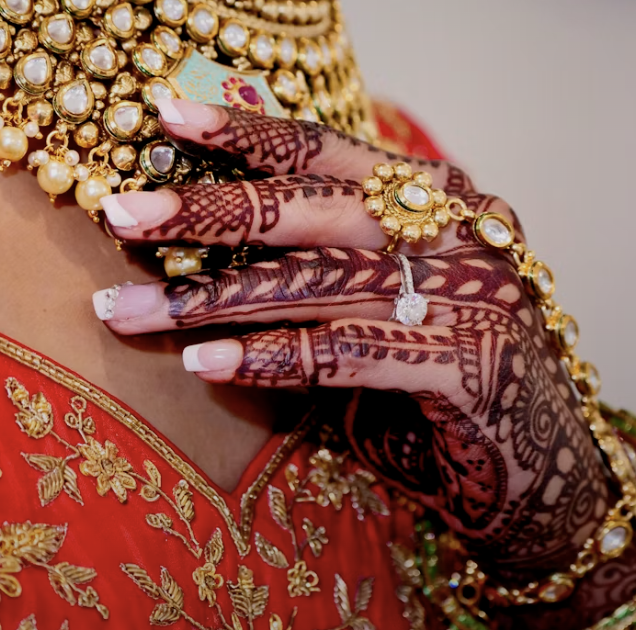 Front hand mehndi design with bold fills and netted patterns
