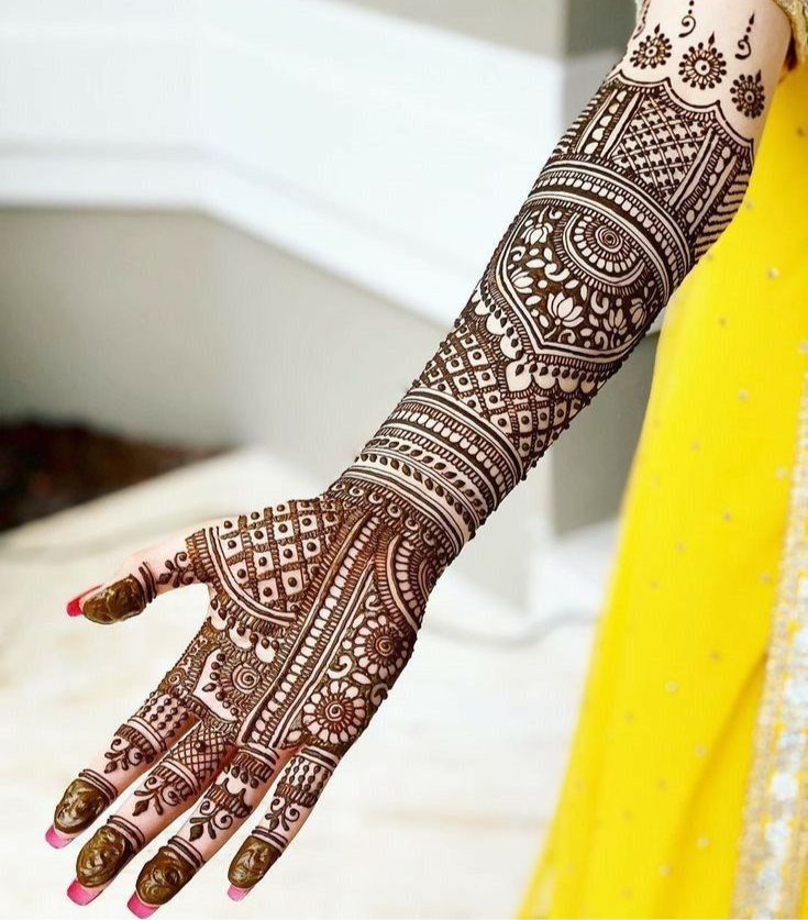 Intricate bridal mehndi on full arm.