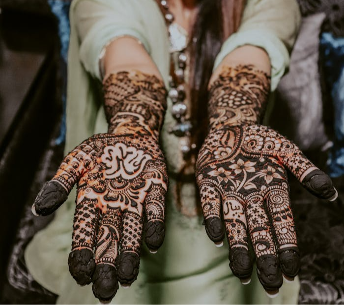 mehndi with dense black coverage, traditional floral and geometric motifs