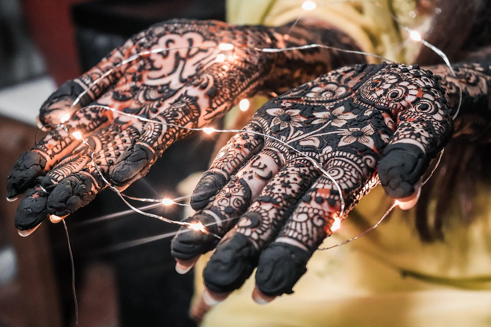 Front hand mehndi with dense floral and paisley patterns, bold fingertip coverage, and traditional filler details