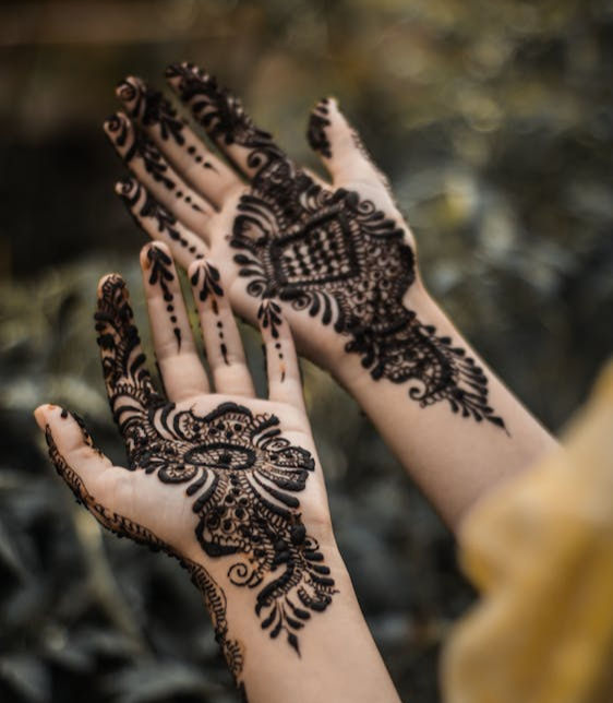 mehndi with bold floral wrist design and sharp vine-like patterns