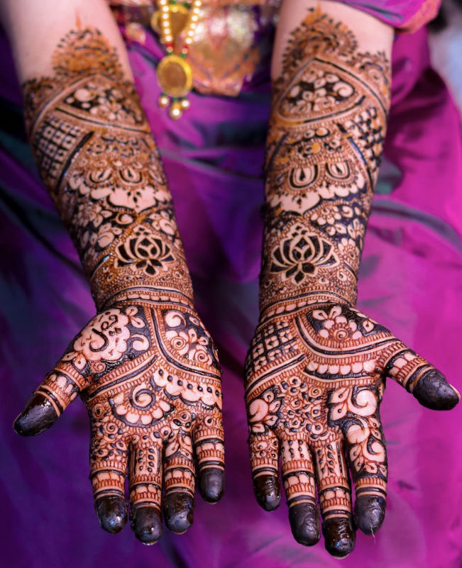 mehndi with full-arm coverage, featuring lotus, paisley, and traditional motifs
