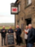 Landlord: What are doin Jane? Landlady: I'm just havin a pint wi some welsh miners. Landlord: Hells bells Jane, tha'll get us locked up serving pints t'kids. Landlady: What a barnpot lads, thick as a train driver's wallet. An Ai image by SPN