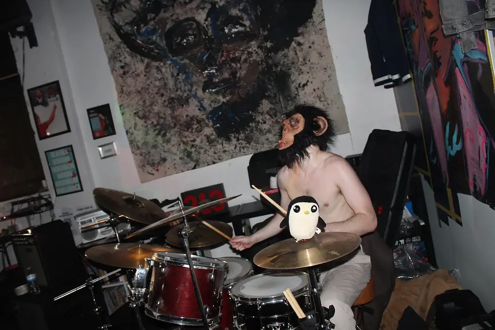 Merrik DeLuca played drums for all four bands; chimpanzee mask secured to his head the entire time, like a soldier’s helmet in Normandy. Source: Owen Armentrout