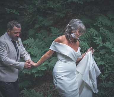 A bride and groom in the forrest after a wedding in hardcastle crags, hebden bridge