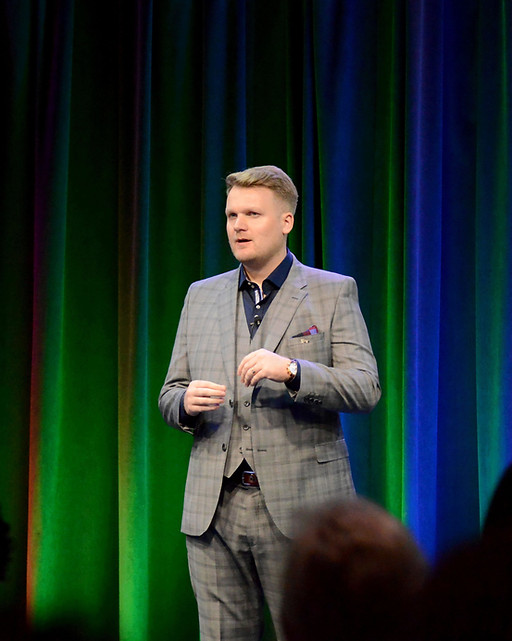 Jack Porter-Smith is standing on a stage, presenting to an audience of business owners at a major conference at Google's Chicago office