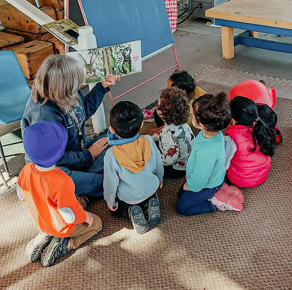 Teacher and kids from Santa Clara Parents Nursery school reading a book together