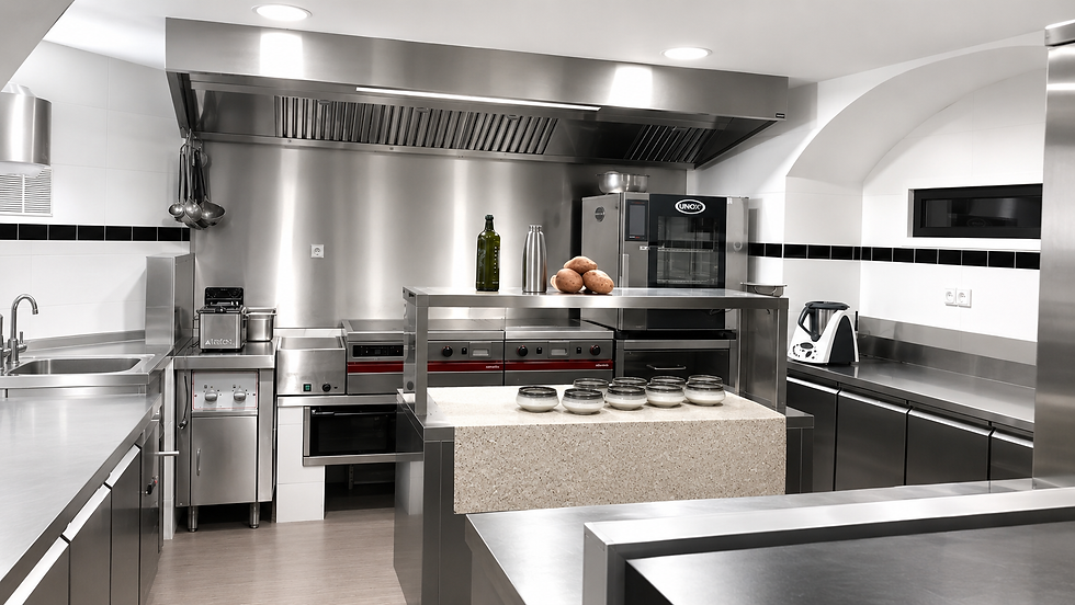 Chef cuisinier dans une cuisine professionnelle. Il porte un tablier blanc et est entrain de travailler.
