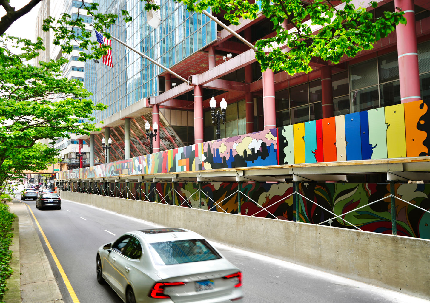 Vibrant, artistic construction barricade graphics wrap around a Downtown Chicago complex, made with special dibond material.