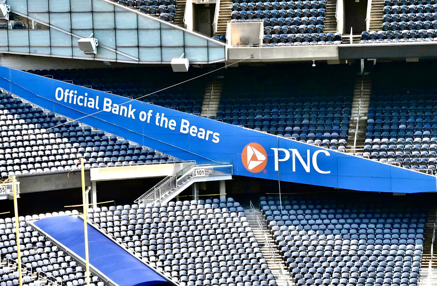Large sponsorship banner inside Soldier Field, featuring bold branding, large-format print graphics, and stadium advertising.