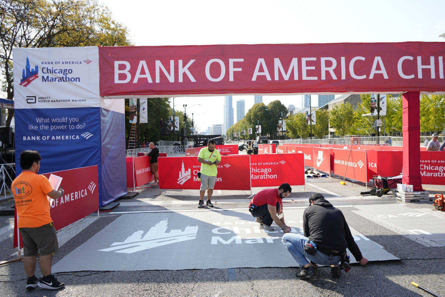 Professional and certified print specialists are installing custom event street graphics at the Chicago Marathon start line.