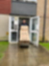 Man moving boxes into apartment building
