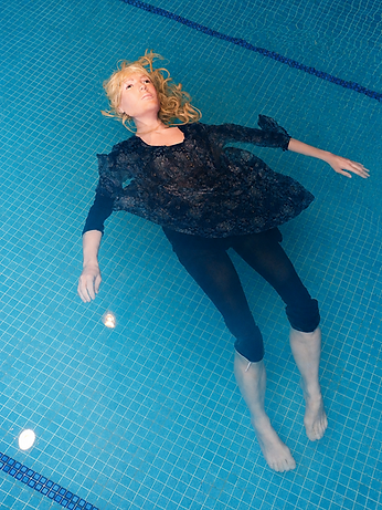 Female stunt dummy floating in a swimming pool