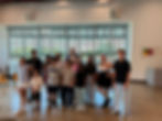 Students and teachers at an in-home music lessons recital.