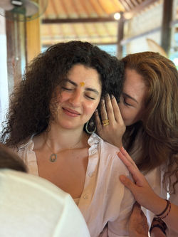 Yoga teacher training student receiving personal guidance