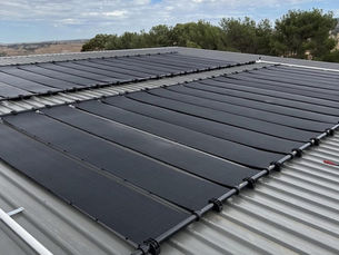 Zane Gulfpanel solar pool heating collectors on a corrugated iron roof